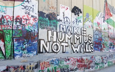 Grafitti saying 'Make hummus not war' painted on a wall